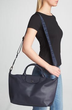 Rich leather and polished logo hardware elevate a spacious tote fashioned with slender top handles and a detachable webbing strap for versatile styling. Logo-jacquard lining Leather Imported Longchamp Le Pliage Neo, Le Pliage Neo, Webbing Strap, Monogram Bag, Longchamp Le Pliage, Shoulder Tote, White Bag, Leather Top, Leather Tote