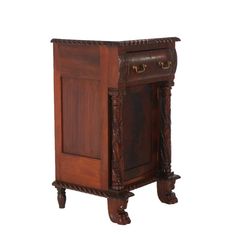 an old wooden cabinet with carvings on the front and sides, sitting against a white background