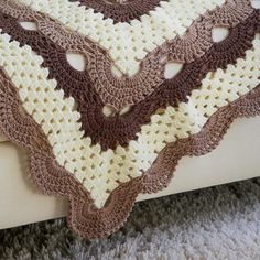 there is a crocheted blanket on the bed