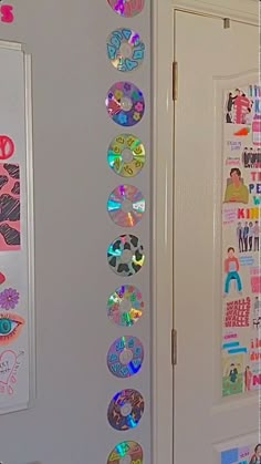 the door is decorated with colorful stickers and magnets on it's side