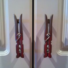 two pairs of scissors hanging on the side of a door