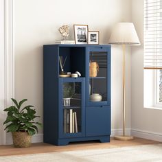 a blue bookcase next to a lamp and potted plant in a room with white walls