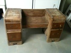 an old wooden desk with two drawers on the bottom and one drawer open to show what's inside