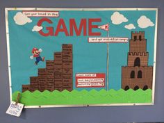 a bulletin board with an image of a castle and mario bros game on it's side