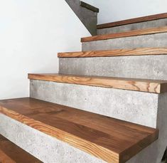 some concrete steps with wood handrails in a house