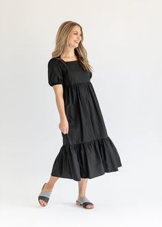 With a joyous style and modest fit, the Ava Square Neck Midi Dress creates a timeless midi dress that can go from day to night in a snap. We love the tiered skirt + the combination of the square neck and puff sleeves! A zipper on the side ensures she is easy to get on and off and sit perfectly across the bust. You are sure to love this clean + classic looking dress! Style: Midi, Short Sleeves SIZING TIPS Fit | Semi-Fitted Stretch | None Models | True to Size Square Neck Midi Dress, Modest Fits, Professional Wardrobe, Church Dresses, Back To School Shopping, Heritage Collection, Dress Gift, The Square, Black Xs