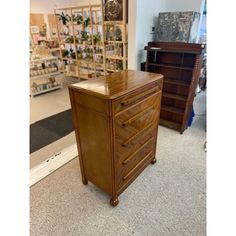 a wooden dresser sitting on top of a carpeted floor