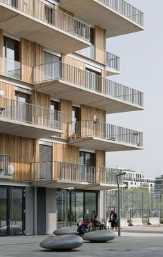 an apartment building with balconies on the second floor