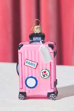 a pink suitcase with stickers on it