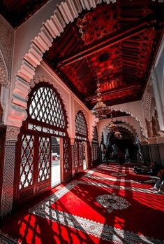 the inside of an ornate building with red carpet