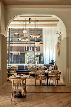 a restaurant with wooden tables and chairs