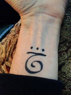 a person with a wrist tattoo that has the number seven on it's arm