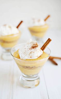 three desserts in small glass bowls with cinnamon sticks