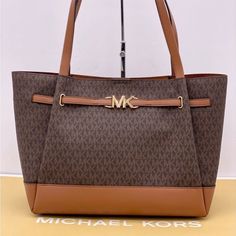 Brand New With Tag Michael Kors Reed Large Tote Bag Tote Bag Logo-Print Canvas Pvc And Leather Trim Color: Signature Brown And Luggage Gold-Tone Hardware 16.5"(Top) X 13"(Bottom) X 10.75"H X 7"D Handle Drop: 11.5" Interior Details: Back Zip Pocket, Front Slip Pocket Lining: 100% Polyester Snap Fastening Imported Coated Canvas Bags With Large Capacity For Errands, Large Capacity Coated Canvas Bag For Errands, Tan Shoulder Bag With Large Capacity In Coated Canvas, Tan Coated Canvas Bag With Top Carry Handle, Michael Kors Coated Canvas Shopping Bags, Michael Kors Rectangular Coated Canvas Bag, Classic Michael Kors Bag For Daily Use, Tan Coated Canvas Bags For On-the-go, On-the-go Tan Coated Canvas Bags