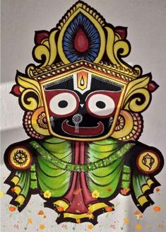 an intricately painted mask hanging on the wall