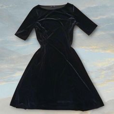 Vintage 90s Black Velvet midi dress  Brand Lands' End Size S (6-8) Black mid length velvet dress with 1/4 sleeves or short sleeves that are a bit longer but shorter than half sleeves, a-line but with a more gradual flare, has some stretch- is black not blue as it looks in one photo Ptp 16.5" Length 39.5"  Very good used condition- just collects hair as velvet does but lint roll before mailing Would make a great dress for the holidays! Help create a more sustainable world by shopping secondhand. This item is made of synthetic materials but is still sustainable because it's vintage- you could say it's recycled! Black Velvet Midi Dress, Velvet Midi Dress, Synthetic Materials, Dress Clothes For Women, Velvet Dress, Lands End, Dress Brands, Black Velvet, Half Sleeves