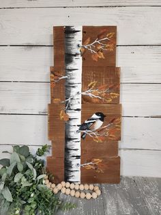 the birch tree has birds painted on it