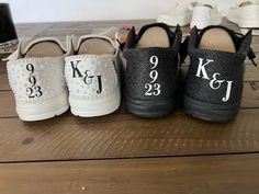 three pairs of black and white baby shoes with the names of each child on them