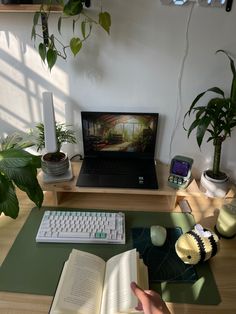 a laptop computer sitting on top of a wooden desk