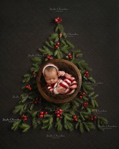 a baby wrapped in a red and white striped blanket sleeping in a wooden bowl surrounded by christmas greenery