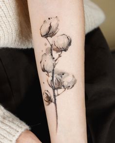 a woman with a tattoo on her arm has a flower tattooed on her left arm