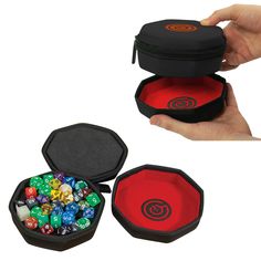 a hand holding a black case with dices in it and two red cases filled with them