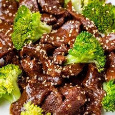 beef and broccoli on a plate with sesame seeds