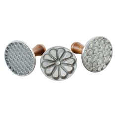 three different types of knobs on a white background and one has a flower design