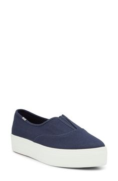 Made from durable cotton canvas with a cushioned footbed, this almond-toe slip-on promises all-day comfort whether you're running errands or exploring the city. The contrast platform cupsole ensures excellent traction and long-lasting wear. 1" platform Pull-on style with elastic gore inset Cushioned footbed Textile upper and lining/rubber sole Imported Navy Slip-on Comfortable Sneakers, Blue Slip-resistant Synthetic Slip-on Sneakers, Navy Slip-on Sneakers With Cushioned Footbed, Blue Slip-resistant Slip-on Sneakers In Synthetic Material, Blue Slip-on Running Sneakers With Cushioned Footbed, Platform Slip On Sneakers, Keds, Running Errands, Slip On Sneaker