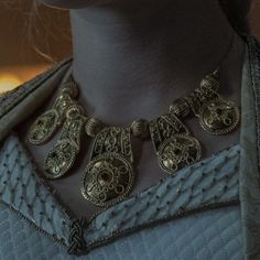 a close up of a necklace on a mannequin's neck with an ornate design