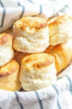 several biscuits are in a basket on a towel