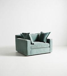 a blue couch with two pillows on it