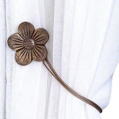 a white curtain with a flower on it