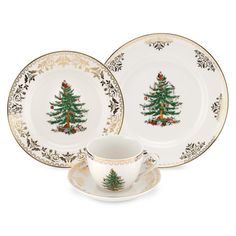 two plates and a cup with a christmas tree on the front, one is gold