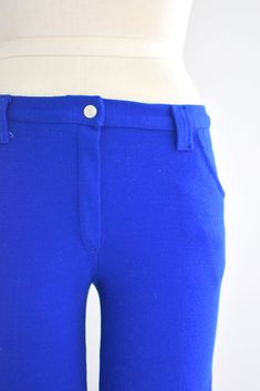 "Description: 1970s bright blue low rise pants. Cotton/polyester knit. Two hip pockets. Snap and nylon zipper closure. Belt loops that can fit a 1.75\" wide belt. Condition: In great condition, with no holes or stains. Designer: Sears Jr. Bazaar Stated Size: 9 Measurements: Waist: up to 30\" (these do not fit the narrowest part of your waist because they are low rise, so take that into account with fit) Hips: up to 36\" Rise: 9.5\" Inseam: 31\" Overall length: 39\" Circumference at hem: 20\" --- Stretch Blue Bottoms With Belt Loops, Retro Blue Bottoms With Belt Loops, Retro Blue Full-length Pants, Retro Stretch Blue Pants, Retro Blue Stretch Pants, Blue Retro Stretch Pants, Retro Stretch Blue Bottoms, Retro Blue Stretch Bottoms, Retro Fitted Blue Bottoms