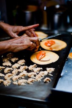 the person is preparing food on the grill