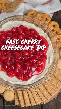 a bowl filled with whipped cream and cherries on top of crackers next to cookies