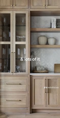 a wooden cabinet with glass doors and shelves in the middle is labeled & lots of it