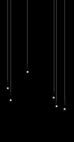 a black and white photo with stars hanging from it's sides in the dark