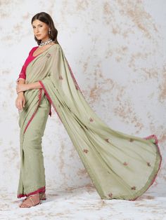 Semi Sheer georgette saree embroidered with pink beads butas and detailed with a contrasting lace. It comes with an unstitched, hotpink georgette blouse piece with beadwork. Color: Sage Green Fabric: Gerogette Note: Wash Care - Dry Clean only The product will be delivered within 3-4 weeks of order placed Relaxed Fit