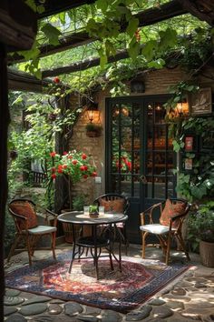 an outdoor dining area with tables and chairs in the middle of it, surrounded by greenery