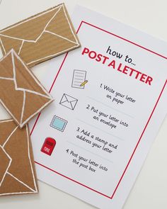 two pieces of cardboard sitting next to each other on top of a white table with an envelope