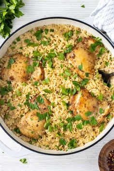 a pan filled with rice and chicken on top of a table