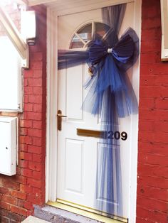 a blue bow on the front door of a house