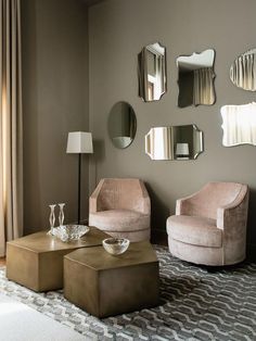 a living room filled with furniture and mirrors