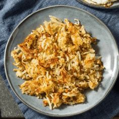 a plate with some food on top of it next to a fork and spoons