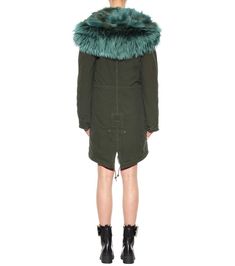 Cosy up in Mr & Mrs Italy's exquisite fur-lined parka this season for the warmest, most luxe way to fend off the chill. The deep green hue is set off with a plush, voluminous fur-trimmed hood with brighter green highlights. The fur lining promises a plush feeling that will prove its worth when you're walking in the snowy city. Size XS material: 100% cotton material II: 100% lamb leather fur: 100% raccoon fur lining: 100% coyote fur sleeve lining: 65% polyester, 20% acetate, 15% viscose care Green Faux Fur Coat With Faux Fur Trim, Luxury Fall Parka With Faux Fur Trim, Luxury Fall Parka With Faux Fur Lining, Snowy City, Green Parka, Coyote Fur, Green Highlights, Mr And Mrs, Deep Green