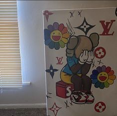 a refrigerator decorated with an image of a cartoon bear on it's side and flowers painted on the front