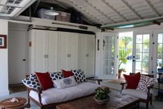 a living room filled with furniture and lots of windows