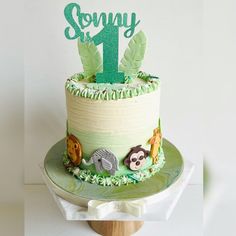 a green and white cake sitting on top of a table